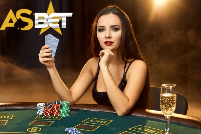 Gorgeous young woman sitting at poker table with glass of champagne Asabet آس بت